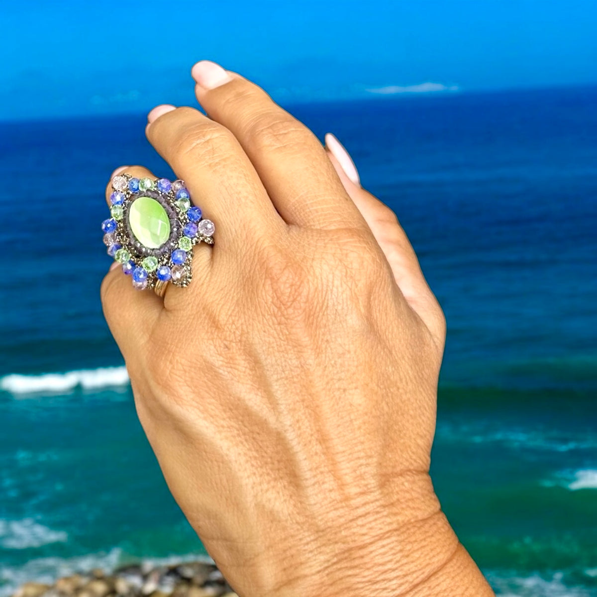 Beautiful Anelli ring worn on a hand against a stunning ocean backdrop.