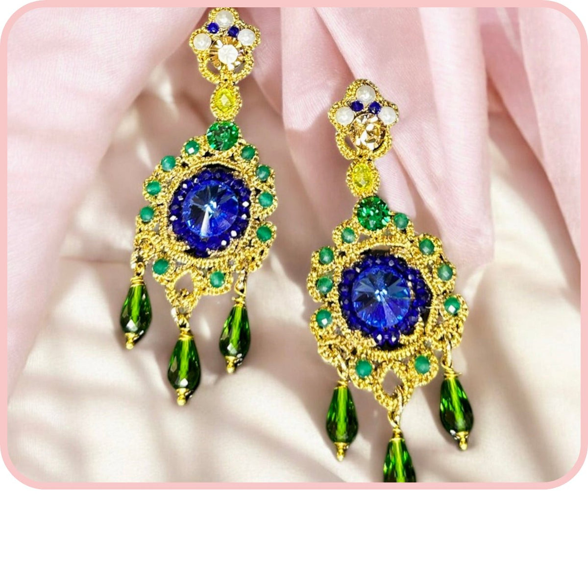 Elegant Lumière earrings featuring vibrant blue and green gemstones set in gold detailing.