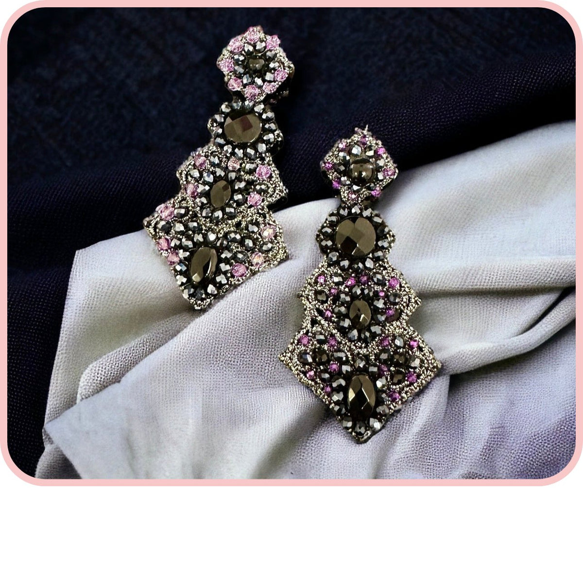Elegant earrings from the Black Edition collection featuring intricate designs and sparkling stones.
