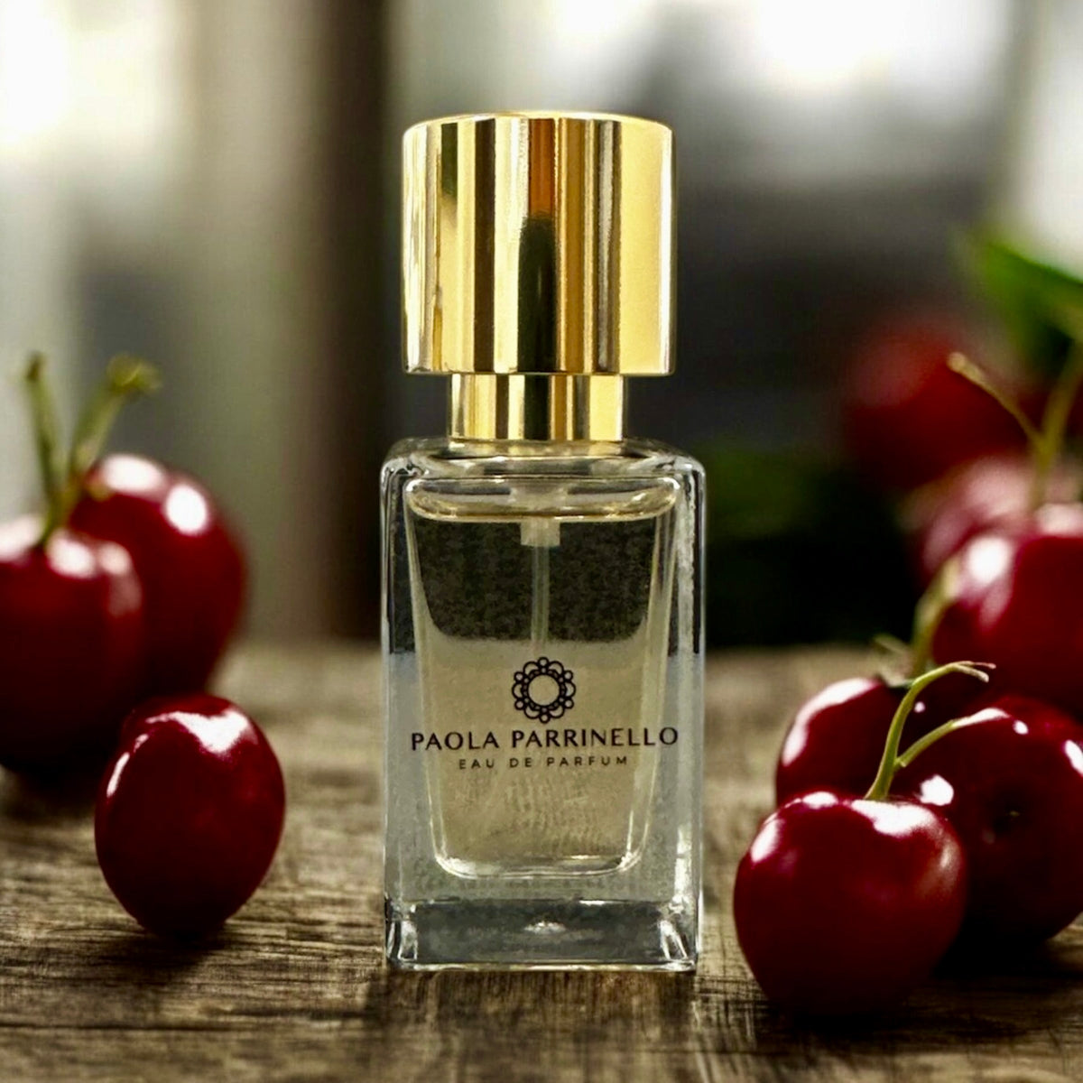 Profumi Paola Parrinello perfume bottle surrounded by cherries