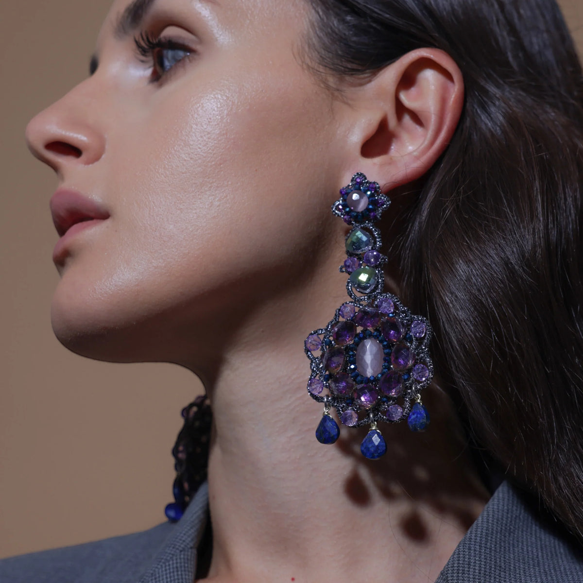 Model showcasing stunning earrings from Collezione Stardust, featuring intricate designs and vibrant colors.